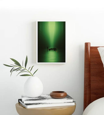 Framed artwork of a green underwater scene on a wall above a side table with decorative items.