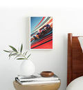 Framed artwork of a racing car on a wall above a table with decorative items.